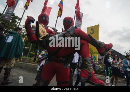 A couple dressed as Deadpool pose for a photo during the third day of the SOFA (Salon del Ocio y la Fantasia) 2021, a fair aimed to the geek audience in Colombia that mixes Cosplay, gaming, superhero and movie fans from across Colombia, in Bogota, Colombia on October 14, 2021. (Photo by Sebastian Barros/NurPhoto) Stock Photo