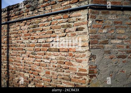 Corner  of a brick wall with piping on it Stock Photo