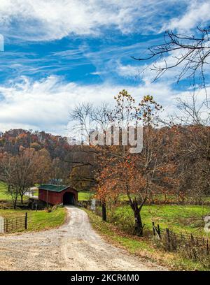 Graysville, Ohio, USA- Oct. 25, 2022: Country autumn landscape with the Foraker Covered Bridge over the Little Muskingum River in rural Monroe County. Stock Photo