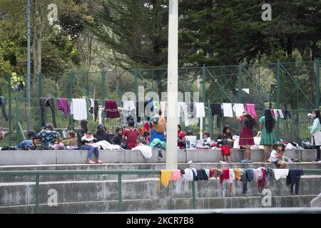 Indigenous people hang their clothes from her after washing them in the national park on October 20, 2021 in Bogota, Colombia. Approximately 1,300 people have been camping in the national park for 20 days, waiting for the government to guarantee their return to their lands due to the violence in the country. (Photo by Daniel Garzon Herazo/NurPhoto) Stock Photo