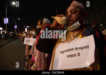 A Hindu Holy Man Blows A Conch Marking End Of Prayer Session On The ...