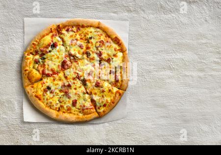 Hot supreme pizza at white stone concrete background texture with copy space. Flat lay, top view Stock Photo