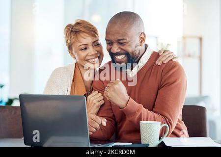 Business, digital success and home couple with computer of black people and winning together. Happy, winner and trading win using technology with a Stock Photo