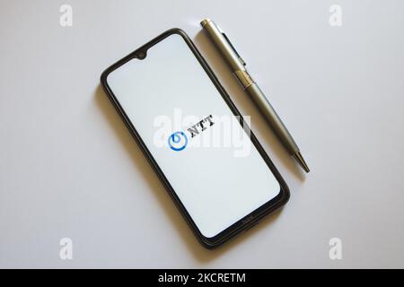 In this photo illustration a NTT logo is display on a smartphone screen and a pencil in Athens, Greece on October 24, 2021. (Photo by Nikolas Kokovlis/NurPhoto) Stock Photo