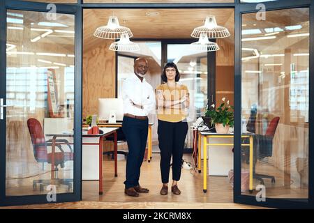 Let us help you design your own future. Portrait of two confident designers standing together in an office. Stock Photo