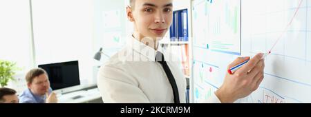 Smart man making presentation of profits for colleagues Stock Photo