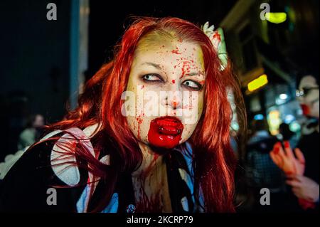 A female zombie with fake blood in her mouth is posing for the camera, during the Zombie walk organized in the center of Arnhem, on October 28th, 2021. (Photo by Romy Arroyo Fernandez/NurPhoto) Stock Photo