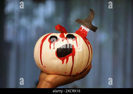 Woman holds a decorated pumpkin the day before Halloween in Toronto Ontario, Canada. on October 30, 2021. (Photo by Creative Touch Imaging Ltd./NurPhoto) Stock Photo