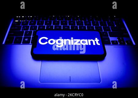 Cognizant logo displayed on a phone screen and a laptop keyboard are seen in this illustration photo taken in Krakow, Poland on October 31, 2021. (Photo by Jakub Porzycki/NurPhoto) Stock Photo