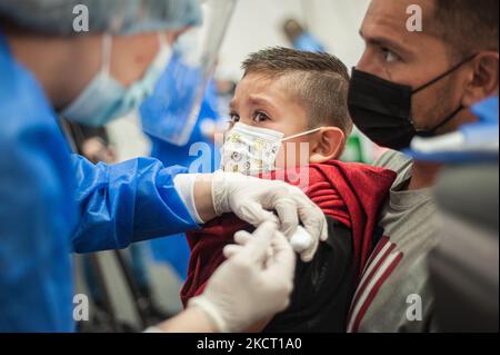 A child cries as he gets the first dose of the COVID-19 vaccine as the Colombian government begins to vaccinate children between ages 3 to 11 against the Coronavirus disease (COVID-19) with the China's SINOVAC vaccine, in Bogota, Colombia on October 31, 2021. (Photo by Sebastian Barros/NurPhoto) Stock Photo