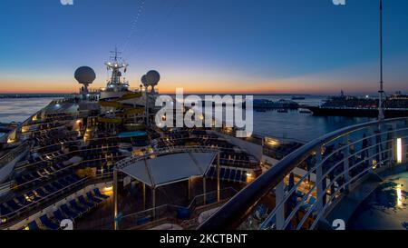 Promenade deck of a cruise ship in navigation with sunset. Stock Photo