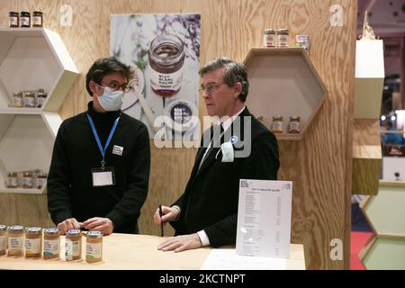 France's former PS (Socialist Party) Economy Minister and left-wing candidate for the 2022 French presidential election Arnaud Montebourg (C), is selling honey produced in France by his company, Bleu Blanc Ruche (bleu white hive) to visitors at the Made in France Fair, a show-window of French know-how at Porte de Versailles in Paris, on November 11, 2021. (Photo by Michel Stoupak/NurPhoto) Stock Photo