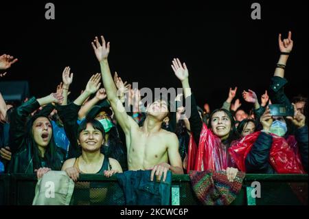 Fans enjoy bands during the first day of the 'IDARTES 10 AÑOS' musical festival that carries rock, metal, punk, salsa and hip hop music across two weekends (20-21 and 27-28 of November) at the Simon Bolivar Park and Scenario 'La Media Torta' in Bogota, Colombia on November 20, 2021. (Photo by Sebastian Barros/NurPhoto) Stock Photo