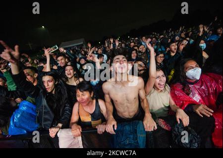 Fans enjoy bands during the first day of the 'IDARTES 10 AÑOS' musical festival that carries rock, metal, punk, salsa and hip hop music across two weekends (20-21 and 27-28 of November) at the Simon Bolivar Park and Scenario 'La Media Torta' in Bogota, Colombia on November 20, 2021. (Photo by Sebastian Barros/NurPhoto) Stock Photo