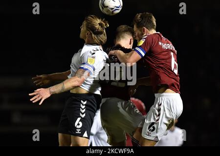 Oldham Athletic's Carl Piergianni tussles with Fraser Horsfall of Northampton Town during the Sky Bet League 2 match between Northampton Town and Oldham Athletic at the PTS Academy Stadium, Northampton on Tuesday 23rd November 2021. Stock Photo