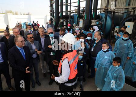 Members of a EU delegation listen to a employee during a visit to a desalination plant in Deir al-Balah in the central Gaza Strip, on November 24, 2021. (Photo by Majdi Fathi/NurPhoto) Stock Photo