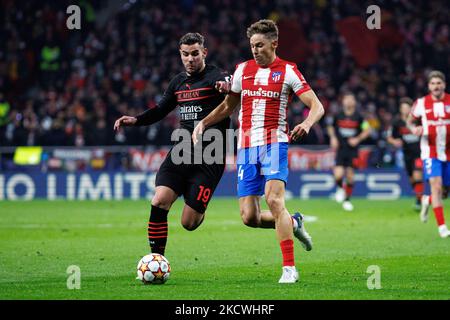 Theo Hernandez of AC Milan in action with Marcos Llorente of Atletico de Madrid during the UEFA Champions League match between Atletico de Madrid and AC Milan at Wanda Metropolitano Stadium in Madrid, Spain. (Photo by DAX Images/NurPhoto) Stock Photo