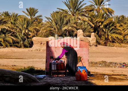 Berber woman fills plastic jugs with drinking water from a community village tap in the High Atlas Mountains in Risine, Morocco, Africa. (Photo by Creative Touch Imaging Ltd./NurPhoto) Stock Photo