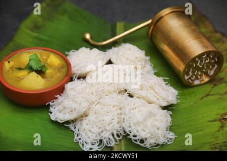 https://l450v.alamy.com/450v/2kcwy51/idiyappam-and-potato-curry-served-on-a-banana-leaf-in-toronto-ontario-canada-on-november-28-2021-idiyappam-also-known-as-string-hoppers-is-a-rice-dish-originating-from-the-indian-states-of-tamil-nadu-and-kerala-it-consists-of-rice-flour-pressed-into-noodles-woven-into-a-flat-disc-like-shape-and-steamed-photo-by-creative-touch-imaging-ltdnurphoto-2kcwy51.jpg