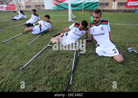 Palestinian amputees using crutches play a football match during a training organized by the Red Cross at Palestine Stadium in Gaza city, on December 2, 2021. Almost 50,000 Palestinians are classified as 'disabled' among the 2-million population of the blockaded Gaza Strip. The number is increasing with more people injured and disabled as a result of Israel's frequent military attacks on the coastal enclave. (Photo by Majdi Fathi/NurPhoto) Stock Photo