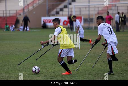 Palestinian amputees using crutches play a football match during a training organized by the Red Cross at Palestine Stadium in Gaza city, on December 2, 2021. Almost 50,000 Palestinians are classified as 'disabled' among the 2-million population of the blockaded Gaza Strip. The number is increasing with more people injured and disabled as a result of Israel's frequent military attacks on the coastal enclave. (Photo by Majdi Fathi/NurPhoto) Stock Photo