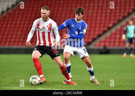 Oldham Athletic's Benny Couto tussles with Aiden O'Brien of Sunderland during the EFL Trophy match between Sunderland and Oldham Athletic at the Stadium Of Light, Sunderland on Wednesday 1st December 2021. (Photo by Eddie Garvey/MI News/NurPhoto) Stock Photo
