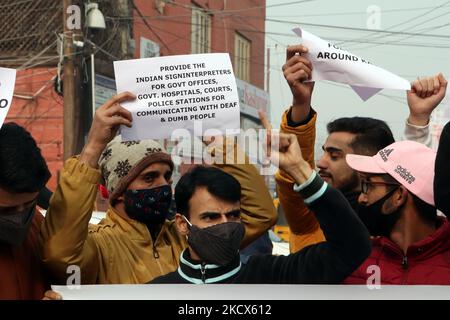 Disable persons hold placards as they protest against the