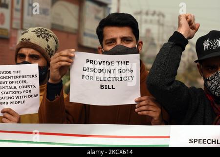 Disable persons hold placards as they protest against the