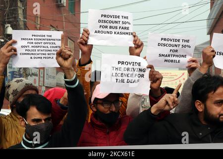 Disable persons hold placards as they protest against the