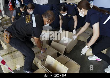 Thai Customs Department unpack evidence as they seized 897 kilograms of crystal methamphetamine worth 2.7 billion baht ($79,733,079) after Thai customs intercepted packages headed for Taiwan, in Bangkok, Thailand, 04 December 2021. (Photo by Anusak Laowilas/NurPhoto) Stock Photo