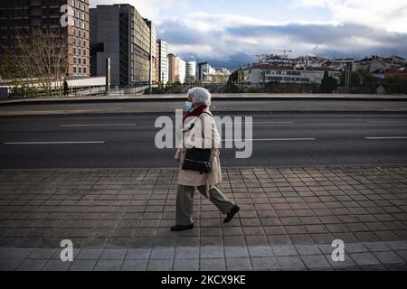 A woman wearing a protective mask walks near Moscavide train station, Lisbon. 04 December 2021. Portugal again recorded excess mortality due to Covid 19. November ended with 1,265 deaths more than the average for the years 2017 to 2019. A quarter of the deaths were caused by Covid. The Mortality Surveillance System, which analyses death certificates in real time, records an excess of deaths in the last 11 days. (Photo by Jorge Mantilla/NurPhoto) Stock Photo