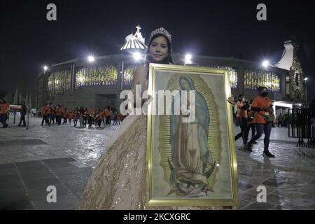 A quinceañera poses outside the Basilica of Guadalupe in Gustavo A. Madero, Mexico City, ahead of the celebration of the Day of the Virgin of Guadalupe in Mexico, to be held in the early hours of December 12. (Photo by Gerardo Vieyra/NurPhoto) Stock Photo
