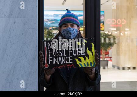 LONDON, UNITED KINGDOM - DECEMBER 10, 2021: A demonstrator holds a placard as activists from Extinction Rebellion and Fossil Free London stage a protest outside Shell's corporate offices against the company's plan to move its headquarters to the United Kingdom on December 10, 2021 in London, England. Today, the shareholders of Royal Dutch Shell are expected to vote on the restructuring proposals which would see the company drop its complex dual share structure and move its tax residency and headquarters from the Netherlands to Britain. (Photo by WIktor Szymanowicz/NurPhoto) Stock Photo