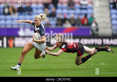 England's Tara-Jane Stanley (left) is tackled by Canada's Petra Woods ...