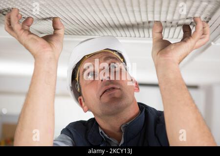 a man holding grill duct Stock Photo