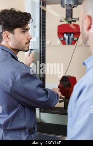 trainer and apprentice in technical training Stock Photo