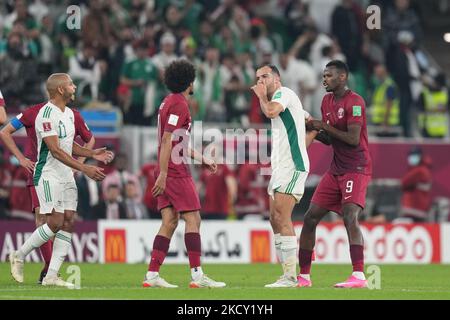 (11) AKRAM AFIF of Qatar quarrel with (4) BENLAMRI Djamel of Algeria team during the FIFA Arab Cup Qatar 2021 Semi-Final match between Qatar and Algeria at Al Thumana Stadium on December 15, 2021 in Doha, Qatar. (Photo by Ayman Aref/NurPhoto) Stock Photo