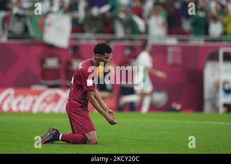 sadness (14) HOMAM AHMED of Qatar team after (10) BELAILI Mohammed of Algeria team score second goal from penalty during the FIFA Arab Cup Qatar 2021 Semi-Final match between Qatar and Algeria at Al Thumana Stadium on December 15, 2021 in Doha, Qatar. (Photo by Ayman Aref/NurPhoto) Stock Photo