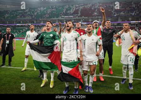 (10) BELAILI Mohammed , (17) DRAOUI Zakaria ,(9) BOUNEDJAH Baghdad ,(14)BENDEBKA Sofiane and (19) BEDRANE Abdelkader of Algeria team celebrate with teammate after match at the FIFA Arab Cup Qatar 2021 Semi-Final match between Qatar and Algeria at Al Thumana Stadium on December 15, 2021 in Doha, Qatar. (Photo by Ayman Aref/NurPhoto) Stock Photo