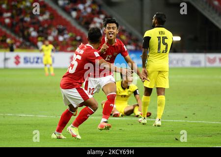 Pratama Arhan Alif Rifai of Indonesia (R) celebrates with Irfan Samaling Kumi after scoring the third goal during the AFF Suzuki Cup 2020 Group B match between Malaysia and Indonesia at National Stadium on December 19, 2021 in Singapore. (Photo by Suhaimi Abdullah/NurPhoto) Stock Photo