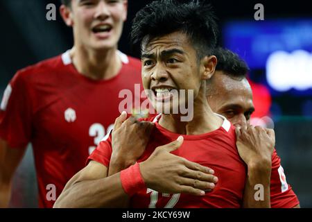 Pratama Arhan Alif Rifai of Indonesia (front) celebrates scoring the third goal during the AFF Suzuki Cup 2020 Group B match between Malaysia and Indonesia at National Stadium on December 19, 2021 in Singapore. (Photo by Suhaimi Abdullah/NurPhoto) Stock Photo