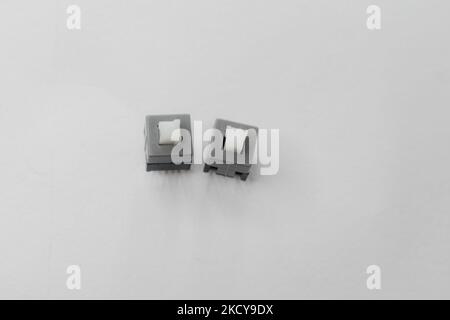 Two momentary push buttons isolated on a white background. Electric push buttons kept on white surface Stock Photo