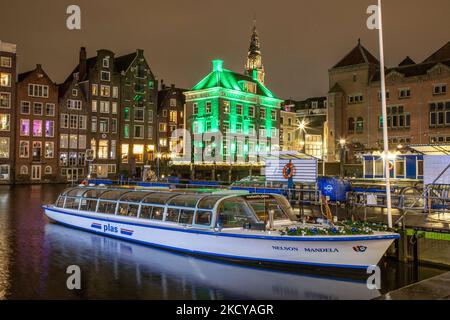 Boats for tours in the canals of Amsterdam at the iconic location with the reclining buildings, mostly operating for tourists are not working due to the lockdown. Streets of Amsterdam during the first day of the sudden lockdown in Dutch capital city. The first European nation declares a full lockdown to fight the new Omicron variant that surges, the Netherlands locks down after the government ordered the closure of all nonessential shops, cafes, restaurants, bars, gyms, schools, sports venues, cultural places and others from Sunday and for 4 weeks in order to prevent the spread of the Omicron  Stock Photo