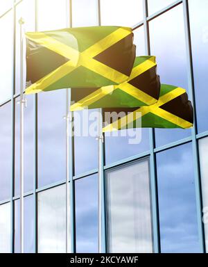 Flagpoles with the flag of Jamaica in front of the business center Stock Photo