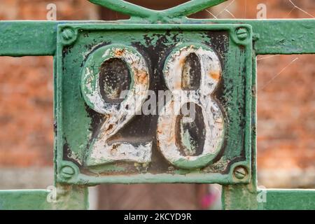 Old retro cast iron plate number 28 closeup Stock Photo