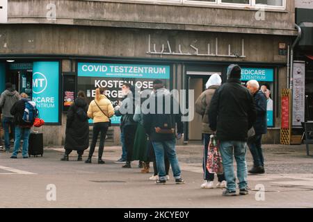 people waits in a long line in front of a coronavirus test center at Christmas eve in Cologne, Germany on December 24, 2021 to speed up vaccination to cope with new Omicron variant (Photo by Ying Tang/NurPhoto)