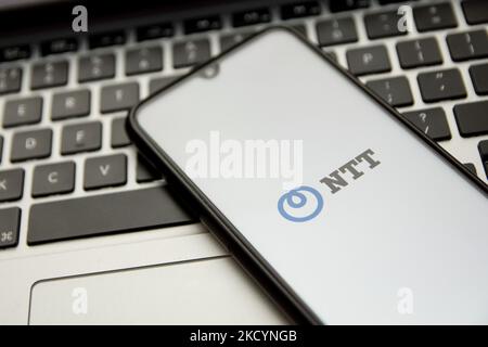 In this photo illustration a NTT logo seen displayed on a smartphone screen with a computer keyword in the background in Athens, Greece on January 2, 2022. (Photo by Nikolas Kokovlis/NurPhoto) Stock Photo