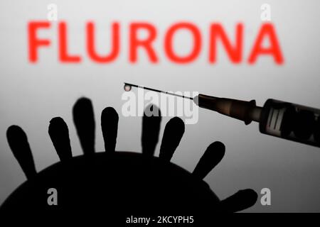 Coronavirus model, medical syringe and 'flurona' sign displayed in the background are seen in this illustration photo taken in Poland on January 4, 2022. Some countries reported cases of patients that were infected both COVID-19 and flu. (Photo by Jakub Porzycki/NurPhoto) Stock Photo