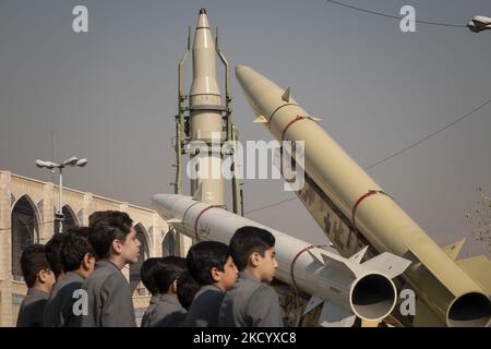 Iranian schoolboys perform as the Iranian Qiam short-range surface-to-surface ballistic missile (C), Solid-propelled road-mobile single-stage missile, Zolfaghar Basir (R), and Dezful medium-range ballistic missile are displayed in a military exhibition to mark the anniversary of an Iran missile attack on the U.S. Ain al-Assad airbase in Iraq in revenge for killing the former commander of the IRGC Quds Force, General Qasem Soleimani, at the Imam Khomeini Grand Mosque in downtown Tehran on January 7, 2022. Iran’s Aerospace Force of the Islamic Revolutionary Guard Corps (IRGC) has attacked the U. Stock Photo