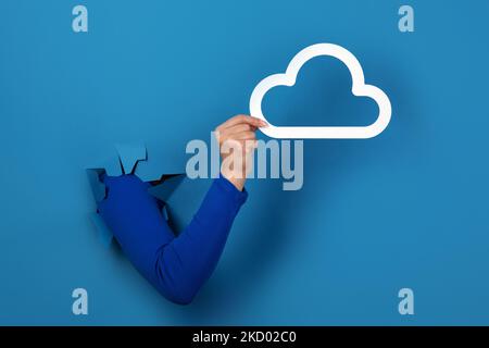hand holding cloud storage over blue background Stock Photo